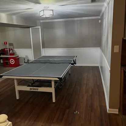 Finished luxury vinyl plank flooring installed in a basement rec room